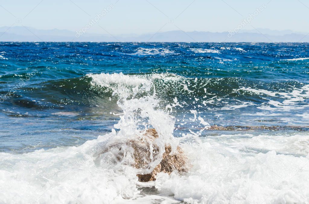 waves and splashes of sea surf and stones on the seashore in Egy