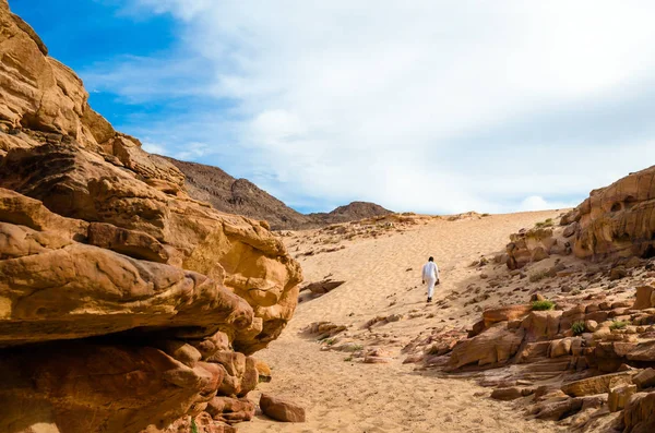 Muž v bílém arabském oblečení chodí v barevném kaňonu v Egyptě Da — Stock fotografie