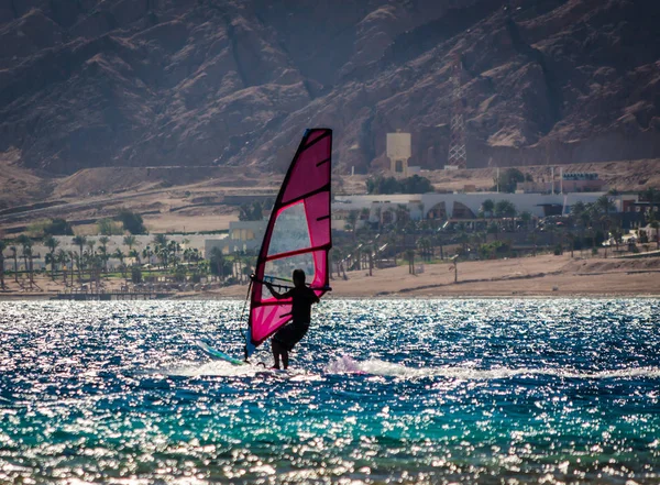 Silhuett av en surfare i Röda havet på bakgrunden av en Roc — Stockfoto