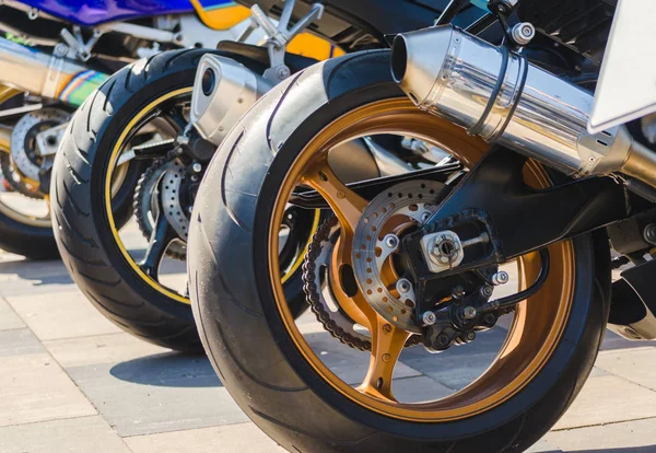 Row of rear wheels of sports bikes in competition — Stock Photo, Image