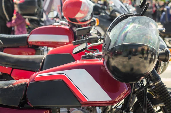 Ряд червоних старовинних мотоциклетних кафе гонщик з шоломами в змаганнях — стокове фото