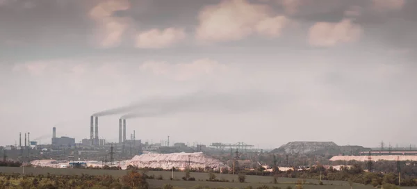 panorama view of the factory with smoking chimneys and the sky w