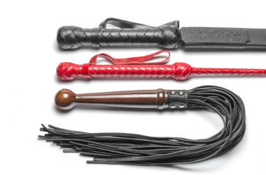 black and red three bdsm whips on a white background close up clipart