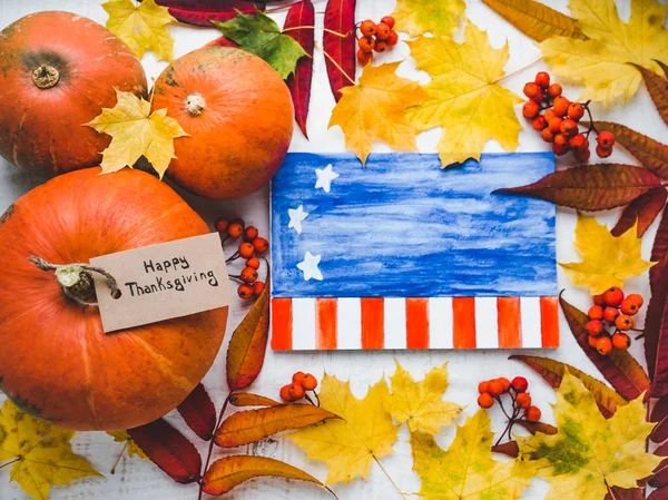 Thanksgiving greeting card, pumpkins and autumn leaves