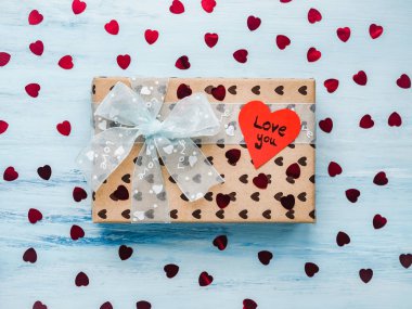 Bir şerit, sevgi ve tinsel kalp şeklinde tatlı sözler notla ile bağlı bir hediye ile kutu. Yakın çekim, düz yatıyordu, izole. Tebrikler sevdiklerini, akrabalar, arkadaşlar ve iş arkadaşları için