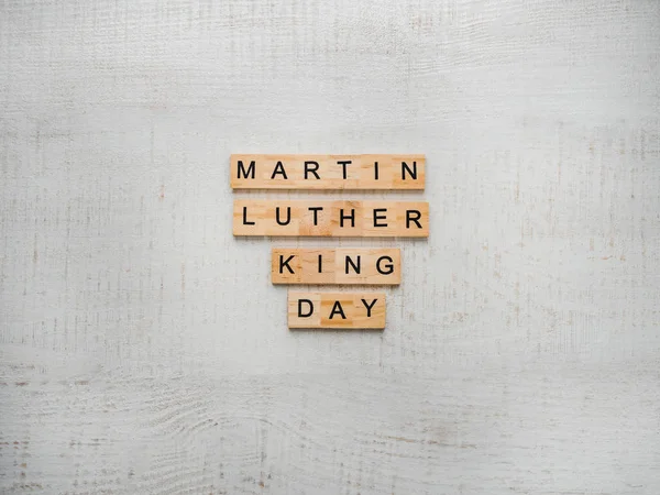 Martin Luther King, Jr. Day. Beautiful greeting card. White isolated background, close-up, top view, wooden surface. Congratulations for loved ones, relatives, friends and colleagues