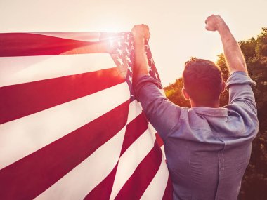Yakışıklı, genç adam Amerikan bayrağı sallıyor