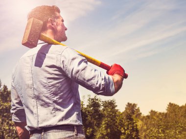 Çekici adam bir çekiç ve Amerikan Bayrağı tutan