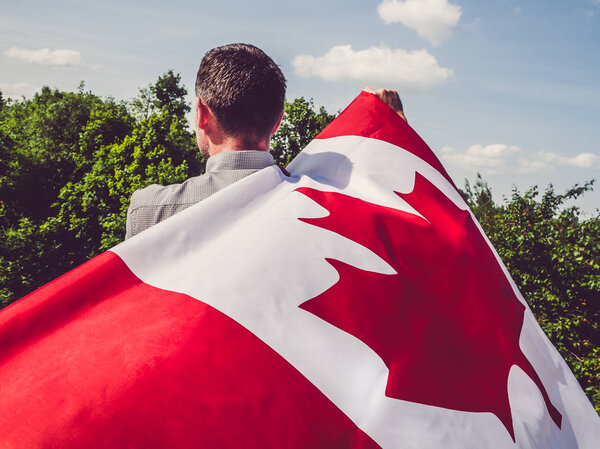 Man waving a Canadian Flag. National holiday