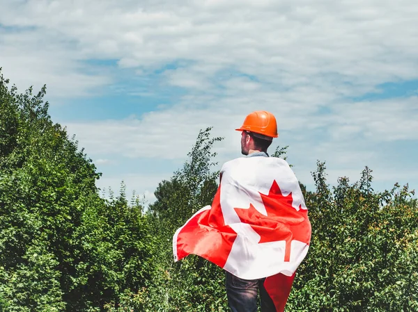 Young engineer, orange hardhat and Canadian Flag — Stock Photo, Image