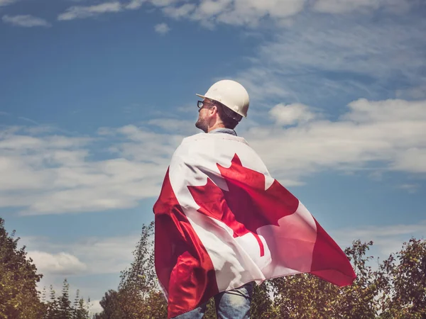 Engineer, holding Canadian Flag in the park — Stock Photo, Image
