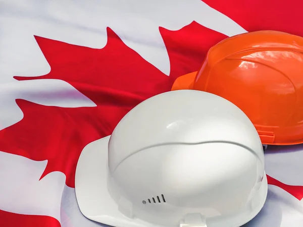 Kanadische Flagge Und Zwei Schutzhüte Nahaufnahme Draufsicht Konzept Von Arbeit — Stockfoto