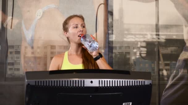 Ritratto di giovane donna atletica su un sentiero pedonale. Carino donna sportiva beve acqua durante l'allenamento. Concetto di vita e sport. 4k — Video Stock