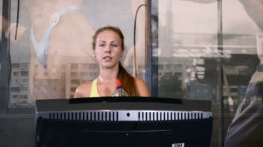 Sevimli sarışın sporcumuz yürüyen bir parça drinkink su eğitim. Yaşam tarzı kavramı. Çekici 20'li yaşlarda. 4k