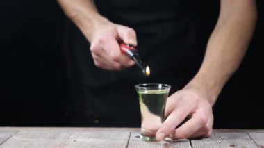 Gece kulübü hayat. Barmen ateşe verir alkol içki kokteyl, yanan tarçın, 180 kare / saniye, barmen içecek yapar. Ağır çekim. HD