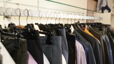 Askıları ile bir alışveriş merkezinde rahat kıyafetler. Yakın çekim: giyim için bir askı. Elbise askıları. Tasarımcı giyim koleksiyonu. Moda butik yeni koleksiyonunda. İnsanlar kavramı yok. HD