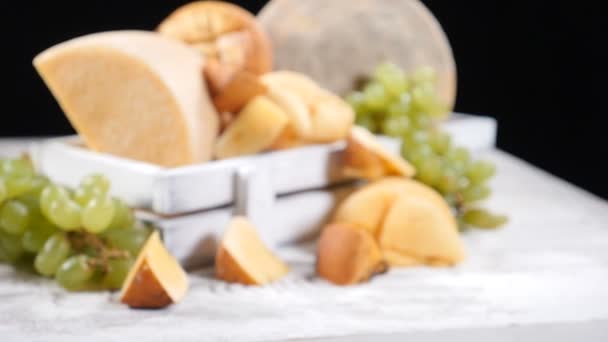 Catering concept. Variety of hard cheese beautifully placed on black background. Zooming in into focus. hd — Stock Video