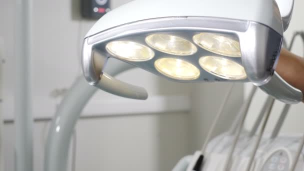 Kvinnlig hand justera Dental LED-belysning innan drift, tandläkare verktyg och professionell tandvård utrustning redo att användas av ortodontist. Kvinnlig tandläkare justera Dental Operations — Stockvideo