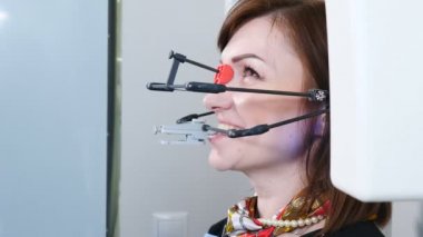 Tıp, diş hekimliği ve sağlık kavramı. Diş teknolojik sürecinin bir parçası. Modern diş hekimi ofisinde Tmj muayene. Çene eklemi kontrolü yaptıran kadın hastanın yakın çekimi. 4k
