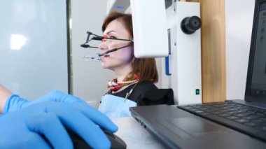 Tıp, diş hekimliği ve sağlık kavramı. Diş teknolojik sürecinin bir parçası. Modern diş hekimi ofisinde Tmj muayene. Çene eklemi kontrolü yaptıran kadın hastanın yakın çekimi. Doktor el