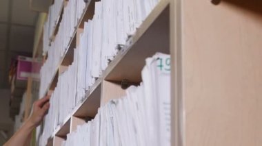 Arşivdeki tıbbi kayıtlar. klinikte katalog. Sağlık kliniği. Hastanede raflarda eski moda sağlık kartları. 4k