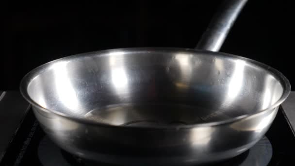 Pouring oil on frying pan . Piece of butter falling in slow motion. Cube of butter starts melting as soon as it is dropped. Food video concept. Cooking is easy. hd — Stock Video