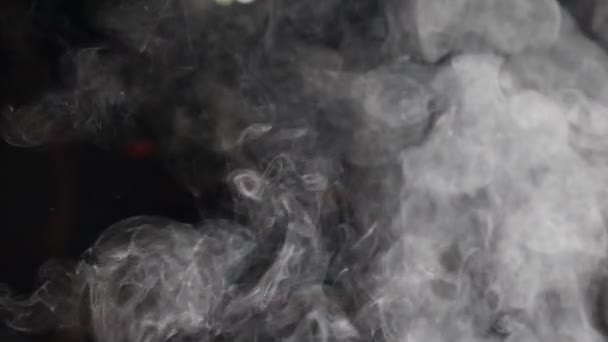 Closeup of white smoke in slow motion on black background. hd — Stock Video