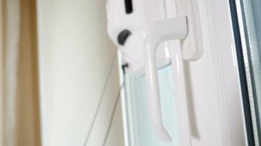 Profesyonel ve amatör temizlik hizmeti konsepti. Robot kare cam temizleyicisi pencerede hareket ediyor. Apartmanın camını temizleyen küçük bir robot. Temassız cam yıkama makinesi. 4k