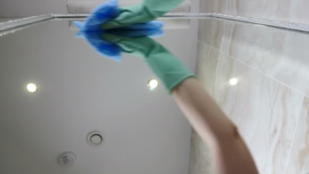 Low angle footage of housemaid cleaning mirror with help of cloth. Modern cleaning service. hotel staff wiping mirror in bathroom. Housemaid in protective gloves cleaning mirror in bathroom. 4 k — Stock Video