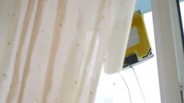 Modern cleaning service concept. Robotic glass washer moving and rotating on window in private apartment. Automatic glass washer working on window. Close-up. 4 k video