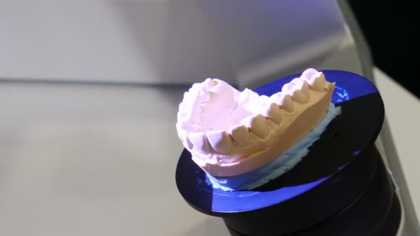 Dental prosthetic restoration. Bright laser moving on surface of gypsum jaw model during scanning inside a dental 3D scanner in modern dental lab. dental technician concept. 4 k video — Stock Video