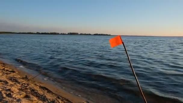Yapımı Kırmızı Bayrak Göldeki Günbatımının Arka Planına Karşı Rüzgarda Titriyor — Stok video