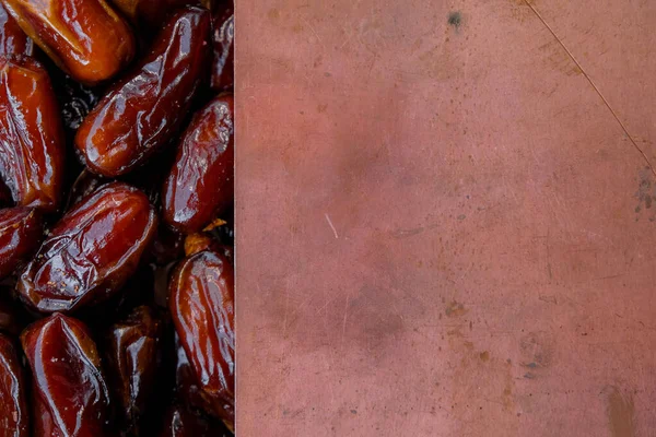 Dried dates and copper surface. Monochrome image. Copy space.