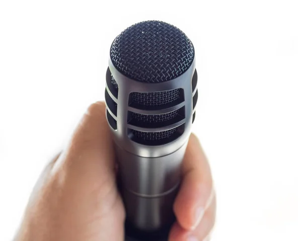 Гладкий Черный Микрофон Подставке Перед Открытым Белым Пространством Рука Белого — стоковое фото