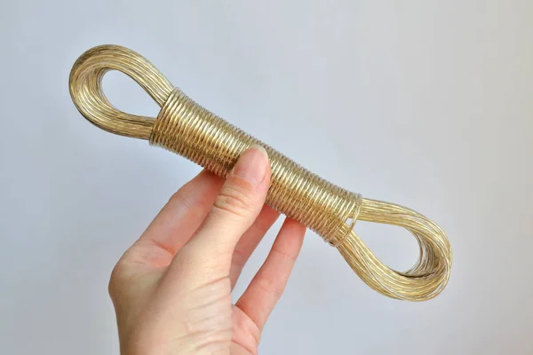 Rope tied in a loop on a white background in a woman's hand, concept against suicide — Stock Photo, Image