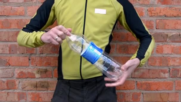 Cherkasy, Ukraine - April 19, 2019 The man reduces the Bonaqua plastic bottle — Stock Video