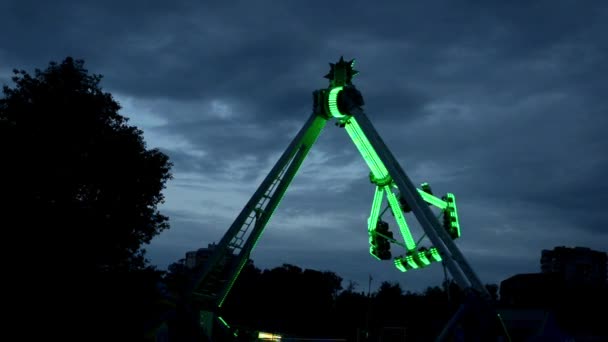 Atracción extrema en Lunapark, con diferentes luces, filmada en la oscuridad en el trabajo — Vídeos de Stock