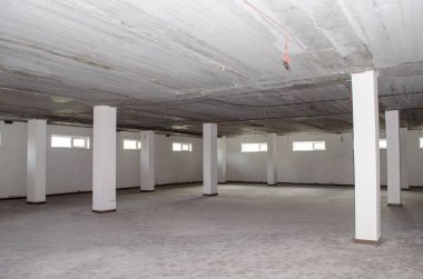 Monolitik binanın gündüz destekleri ve pencereleri olan boş, parlak bir alanı var.