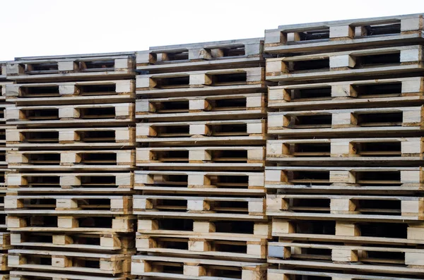 Stacks of wooden pallets for industrial transportation by trucks or for processing into furniture
