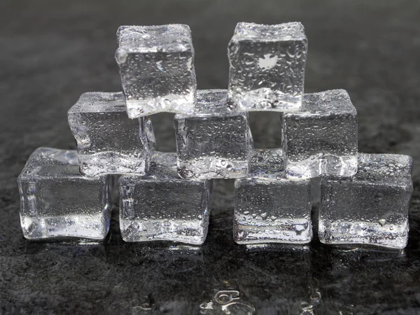 ice cubes against a dark background.