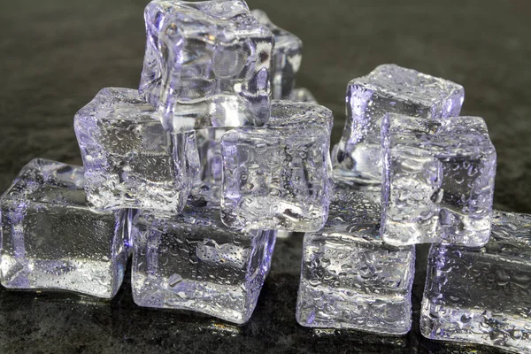 ice cubes against a dark background.