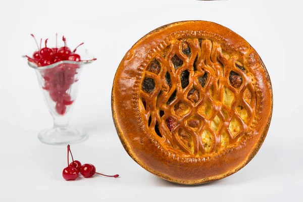 Fresh casserole with poppy seeds, cheese and cherries. Homemade pastries on a white background.