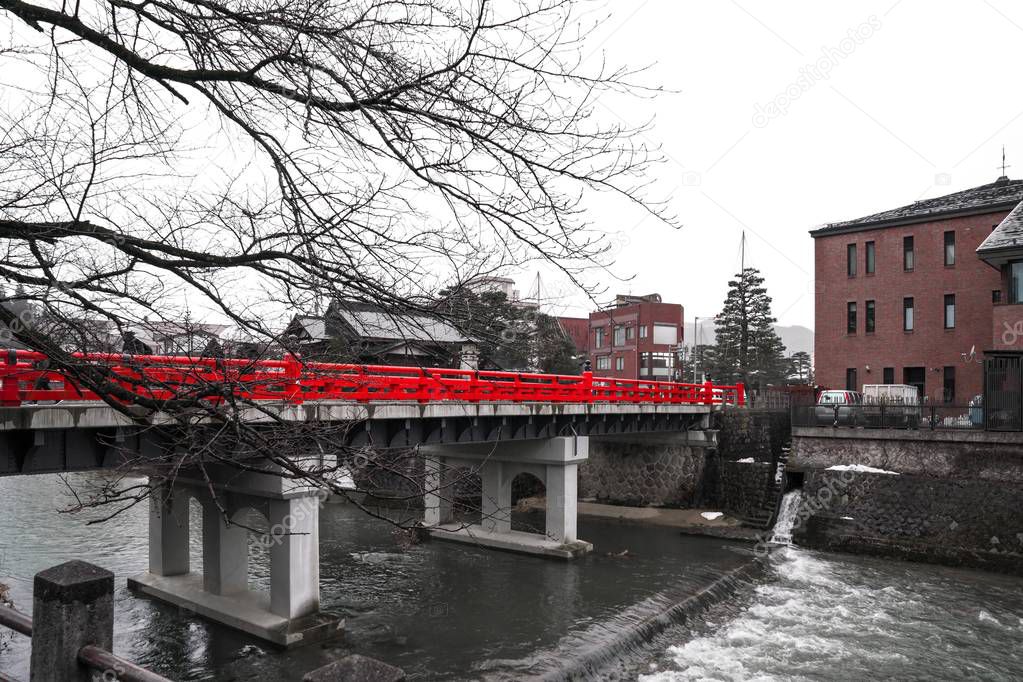 Red bridge in little Kyoto in a little snowing and raining fall.
