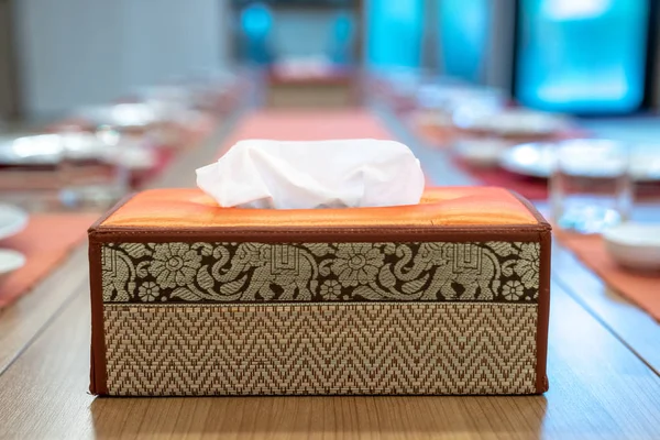 Asia Thai tissue box, elephant pattern lay on the Japanese dinner table with blur background.