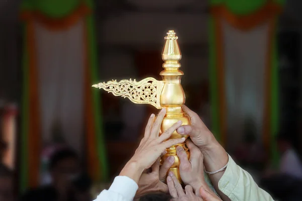 united people; close up their hands, rise up the holy gold top of the temple decoration together in religion local traditional ceremony.