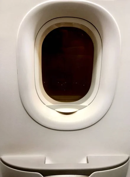 close up emergency window and door of low cost plane, photo shoot from the inside out at the night