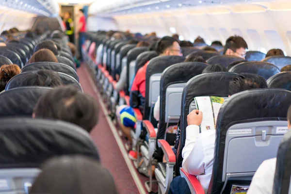 Asian Passenger Reading Magazine Menue Catalog While Waiting Plane Take — Stock Photo, Image