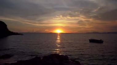 Güzel günbatımı ve bulutlar bir cennet ve cennet gibi rock ve tekne ile plajda Timelapse.