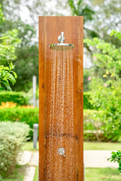 Outdoor shower head stick on the wooden plate pole design for sh — Stock Photo, Image