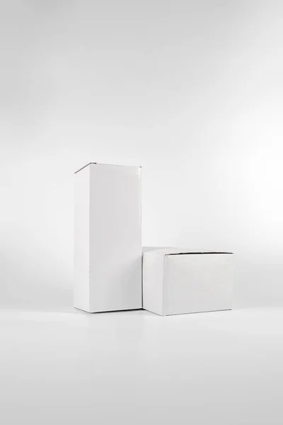 White two paper boxes - tall and fat lay on the white background — Stock Photo, Image